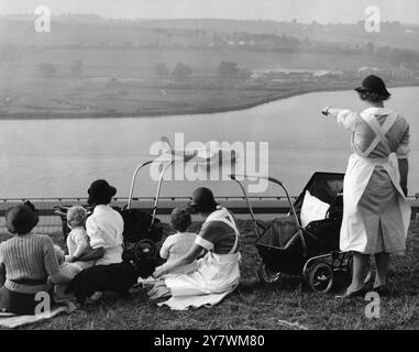 Nursemaids in Rochester , Kent , have a good view of the flying boat tests on the River Medway where the Mayo dual flying boats are being constructed .  The flying boat in the picture is one of the the Empire Class ' Cambria ' arriving back after a test flight - 27 September 1937 ©TopFoto Stock Photo