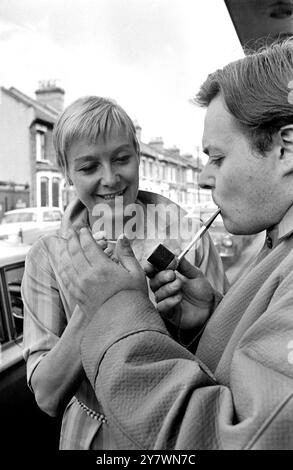 Actor Bill Wallis wearing a raincoat popularised by Premier Harold Wilson gets a light for his pipe from actress Myvanwyn Jenn . Bill and Myvanwyn will take the part of the Prime Minister and his wife in a play at the Theatre Royal in Stratford , London called Mrs Wilson's Diary . The theatre won a six month battle with the Lord Chamberlain's office to present the play . 18 September 1967 Stock Photo