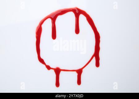 Leaking red blood stain on white background Stock Photo - Alamy