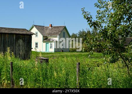 Wooden Cabins surrounded by nature at Ukrainian Heritage Village in Canada, on a sunny day Stock Photo