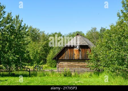 Wooden Cabins surrounded by nature at Ukrainian Heritage Village in Canada, on a sunny day Stock Photo