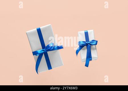 Flying gift boxes on beige background Stock Photo