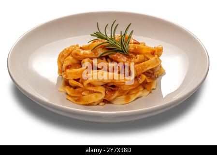 Tagliatelle egg pasta with red tomato sauce and rosemary sprig in white plate isolated on white Stock Photo