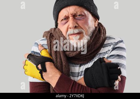 Frozen homeless man on light background, closeup Stock Photo