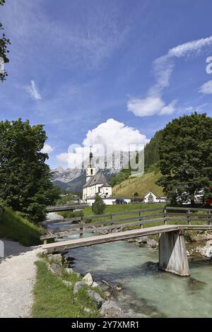 Parish church of St. Sebastian in autumn with Ramsauer Ache, Reiteralpe in the background, Ramsau, Berchtesgaden, Berchtesgadener Land, Upper Bavaria Stock Photo