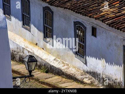 Old houses and cobblestone pavement on a historic street in the city of Ouro Preto in Minas Gerais, Ouro Preto, Minas Gerais, Brazil, South America Stock Photo