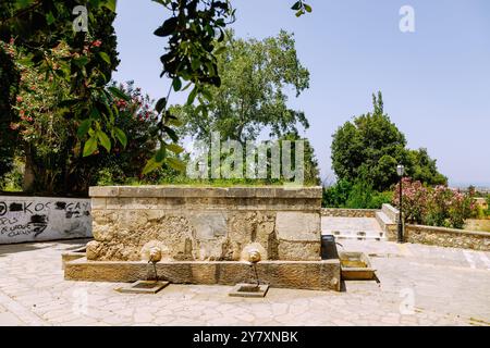 Fountain decorated with lion heads Paleo Pigi (Old Water Spring) in Pyli (Pili) on the island of Kos in Greece Stock Photo