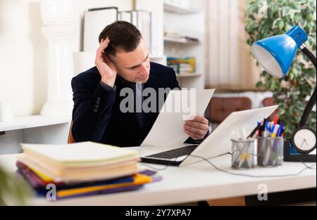 Angry male manager experiencing emotions in office Stock Photo