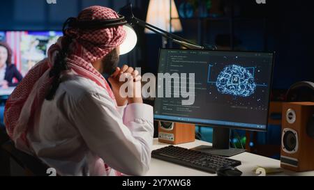 Arab admin using computer to visualize artificial intelligence neural networks made up of interconnected nodes using augmented reality technology. Developer oversees AI systems processing information Stock Photo