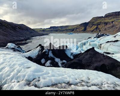 Vatnajokull glacier ice cap in iceland melting due to climate change, huge chunks of ice floating around frosty lake or glacier lagoon. Icy blocks with diamond shape forming nordic scenery. Stock Photo