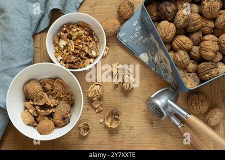 Open and closed walnuts with nutcracker Stock Photo
