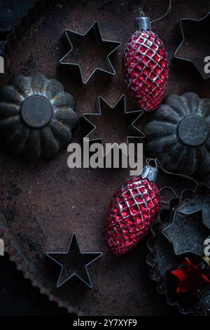 Old cookie cutters on tin with old Christmas tree decorations Stock Photo