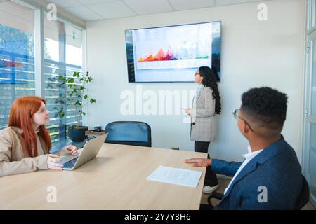 Latin businesspeople teamwork working in a collaborative project in bright co-working office space  Stock Photo