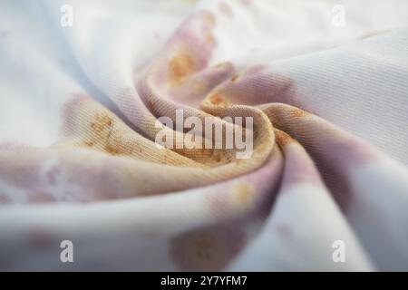 An Elegant Swirl of Soft White Fabric Enhanced by Subtle and Intriguing Color Stains Stock Photo