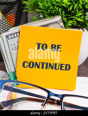 TO BE CONTINUED text written on a yellow sticker, vertical concept photo Stock Photo