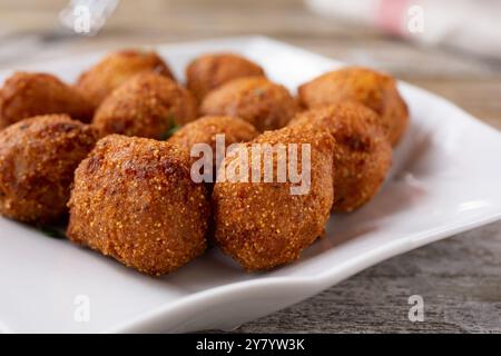 A closeup view of a plate of deep fried hush puppies. Stock Photo