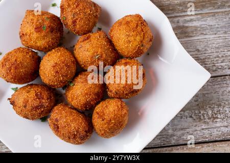 A top down view of a plate of deep fried hush puppies. Stock Photo