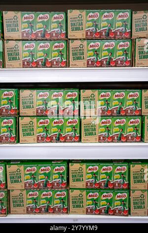 A neatly arranged shelf filled with boxes of Milo chocolate malt