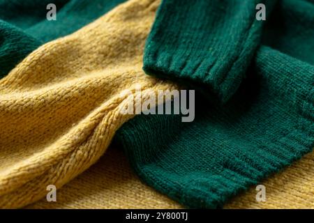 Two hand knitted wool sweaters. Background textures. Stock Photo
