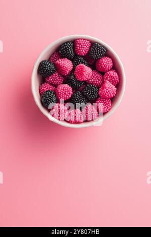 Sweet jelly candies in bowl on a pink background. Top view. Stock Photo