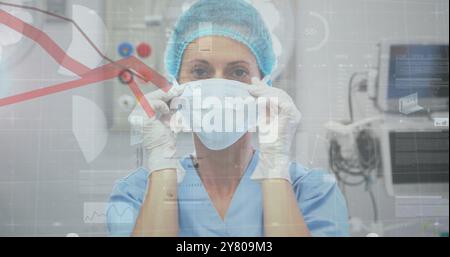 Image of statistics and data processing over caucasian female surgeon Stock Photo