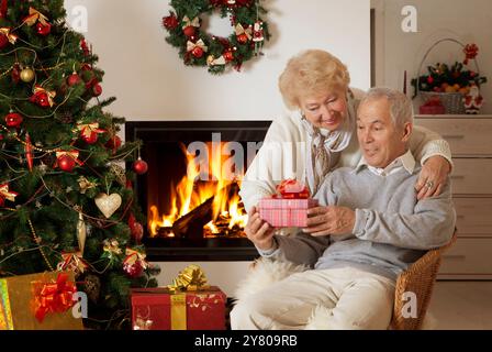 Happy senior man getting Christmas present, satisfied Stock Photo
