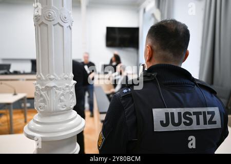 Ravensburg, Germany. 02nd Oct, 2024. A 34-year-old defendant enters the courtroom in handcuffs. The defendant is accused of attacking a four-year-old girl with a knife in a supermarket. Credit: Felix Kästle/dpa/Alamy Live News Stock Photo