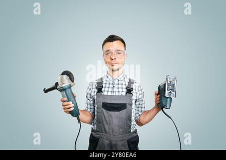 Portrait of a Worker Holding Power Tools in Both Hands Stock Photo