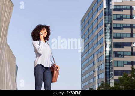 cheerful female entrepreneur talking on phone Stock Photo