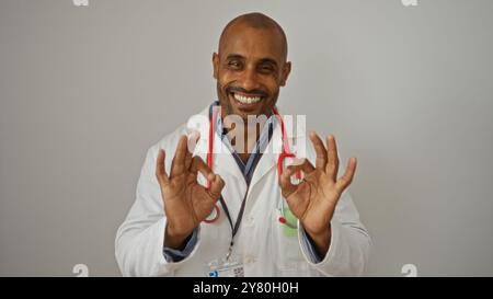 Smiling doctor making ok gesture with both hands over isolated white background Stock Photo