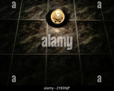 Illuminated Elegance: Light Bulb and Black Marble Tiles in a Bathroom Setting Stock Photo