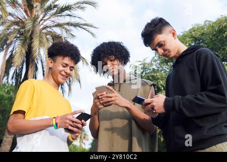 teen friends having fun using mobile phones Stock Photo