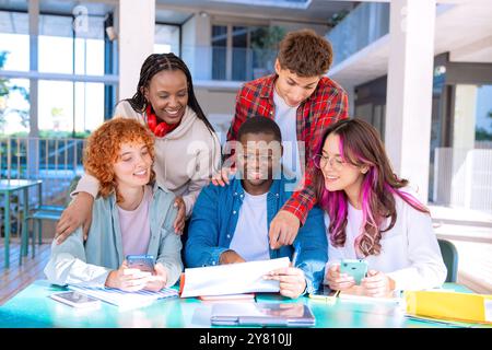 Happy diverse group of students studying in the library Stock Photo