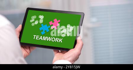 Tablet screen displaying a teamwork concept Stock Photo