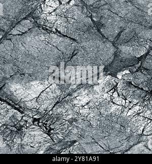 The rocky surface is gray with cracks and irregularities Stock Photo