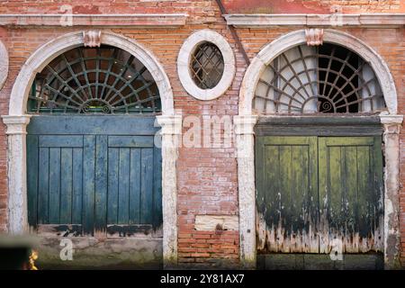 Background with two aged doors. Colours of Venice.  Terracotta, teal and antique green. Harmonious combination of colors. Stock Photo