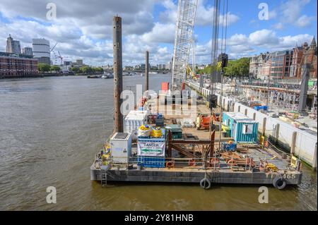 London, UK. Crane moored by a construction site on the Thames by Blackfriars Bridge Stock Photo