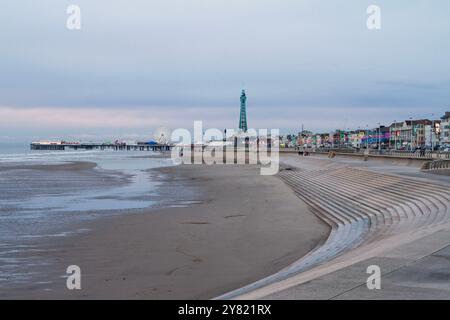 The iconic Blackpool Tower and pier standing proudly in the background. This serene moment captures the perfect blend of nature and nostalgia. Stock Photo