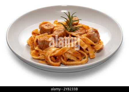 Tagliatelle egg pasta with red tomato sauce with sausage pieces and rosemary sprig in white plate isolated on white Stock Photo