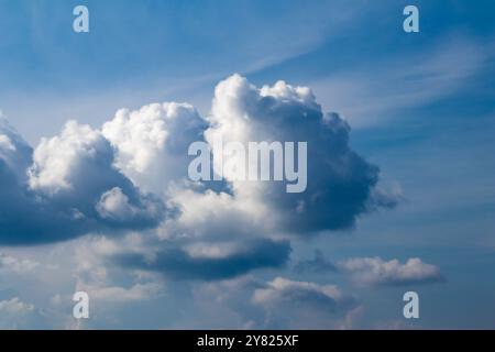 Cloudy blue sky, white clouds background with deep blue sky. Wallpaper with sunlight. Texture, pattern idea concept. Horizontal photo. No people. Stock Photo
