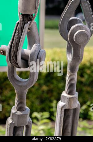 Metal ring and Steel cabling attached to a shackle. Steel wire rope slings with Thimble and safety anchor shackle turnbuckle connection bolt for heavy Stock Photo