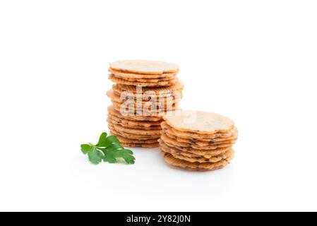 Stack  of thin round crispbreads with herbs isolated on white Stock Photo