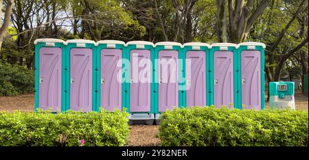 Portable mobile toilets in the park. A line of chemical WC cabins for an event in Japan Stock Photo