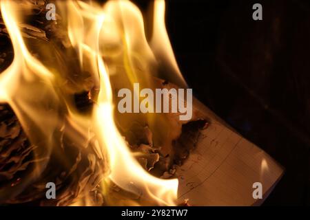 A document burning in flaming fire. Stock Photo