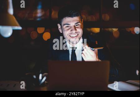 Cheerful Businessman Talking On Cellphone Using Loudspeaker Sitting In Office Stock Photo