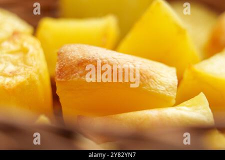 Golden roasted potatoes with crispy crust. Delightful side dish ready to eat. Macro Stock Photo
