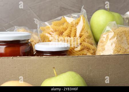 Different food products for donation in box, closeup Stock Photo