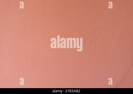 Minimalist textured pink wall under soft lighting. Stock Photo