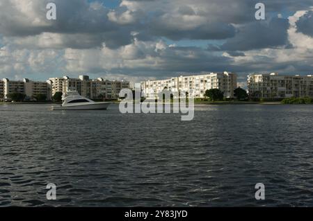 View from over intercoastal  towards blue near Corey Causeway Drawbridge. Fishing Boats and  Sailboats in the middle Towards far shore and condos. Puf Stock Photo