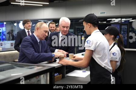 Moscow, Russia. 02nd Oct, 2024. Russian President Vladimir Putin, left, and Moscow Mayor Sergei Sobyanin, center, order coffee drinks during a tour of the onsite college training at the Rudnevo Industrial Park, October 2, 2024 in Moscow, Russia. Credit: Gavriil Grigorov/Kremlin Pool/Alamy Live News Stock Photo